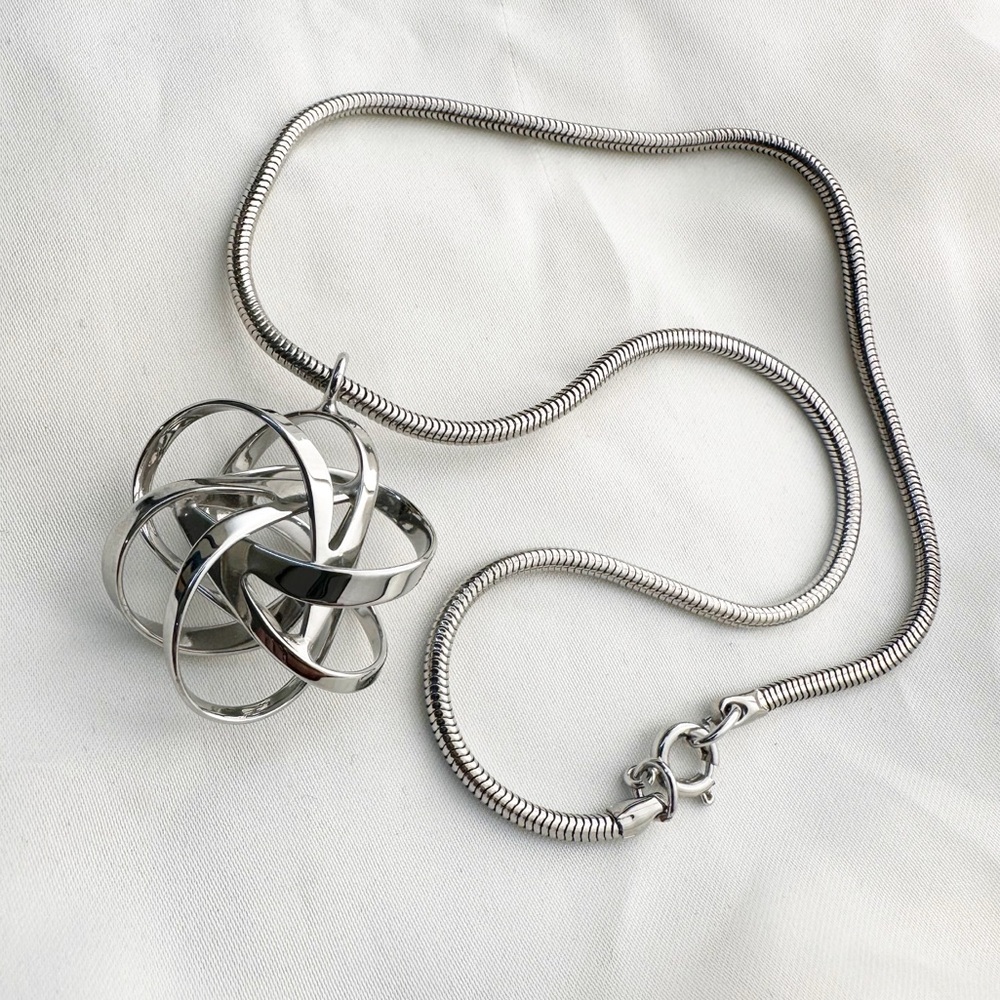 Silver tone modernist knot pendant necklace